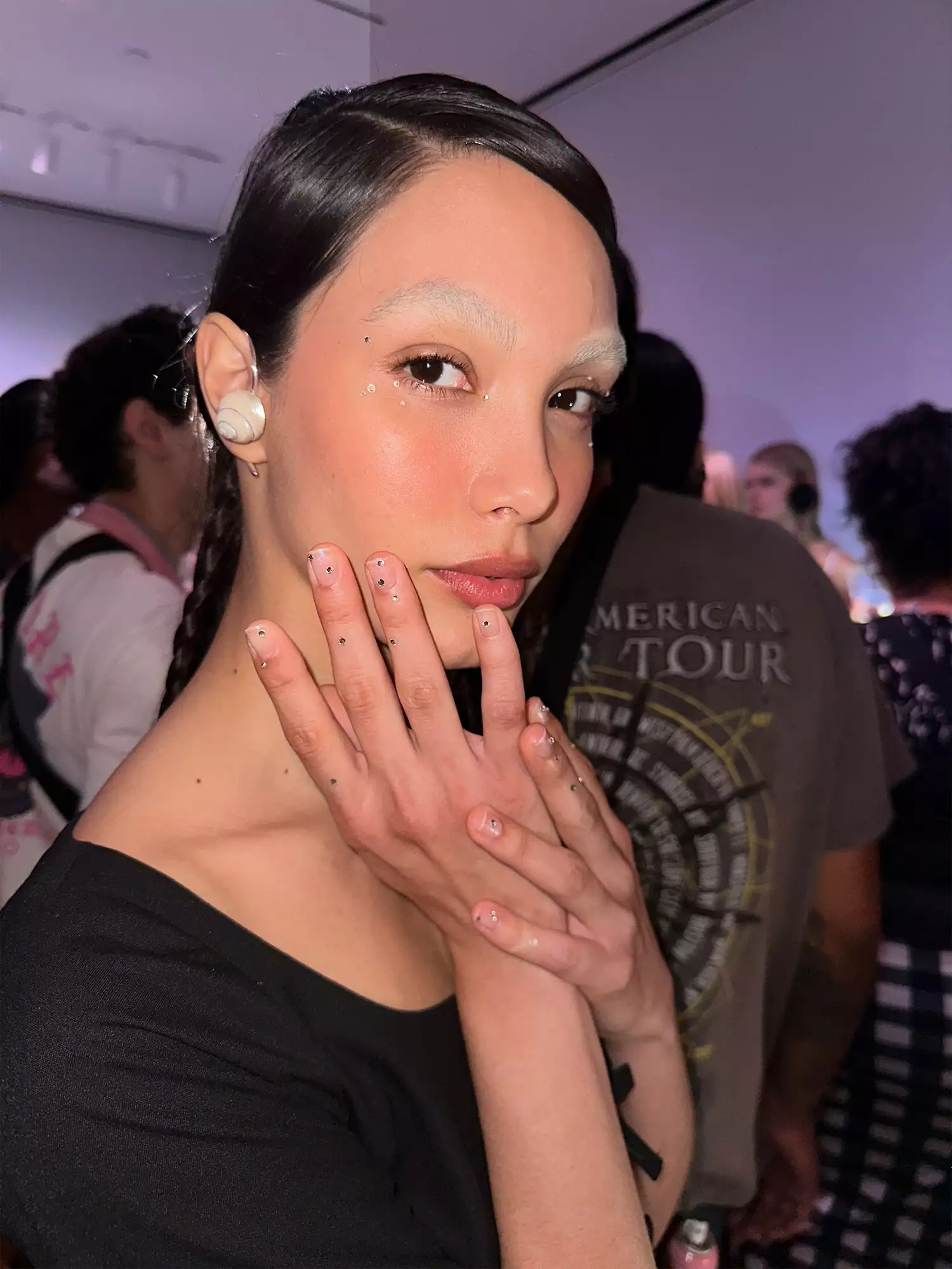 A woman wearing crystal decals, one of the Spring 2024 nail trends