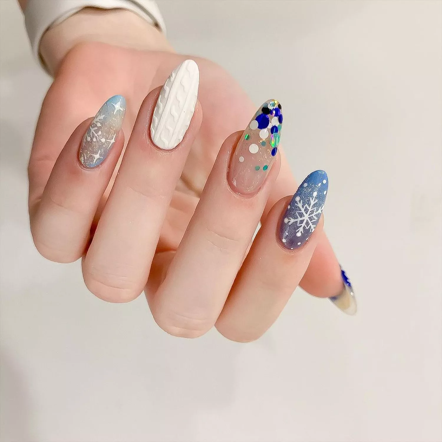 mismatched winter manicure with snowflakes, sparkles, and glitter