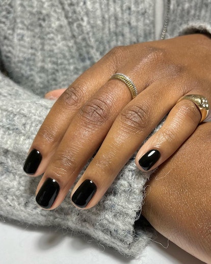 One of the most popular winter nail polish color trends for 2024 is glossy black.