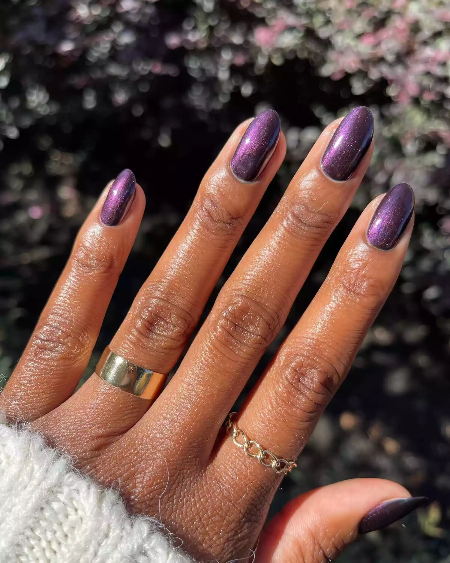 Close up of a glazed plum-colored manicure