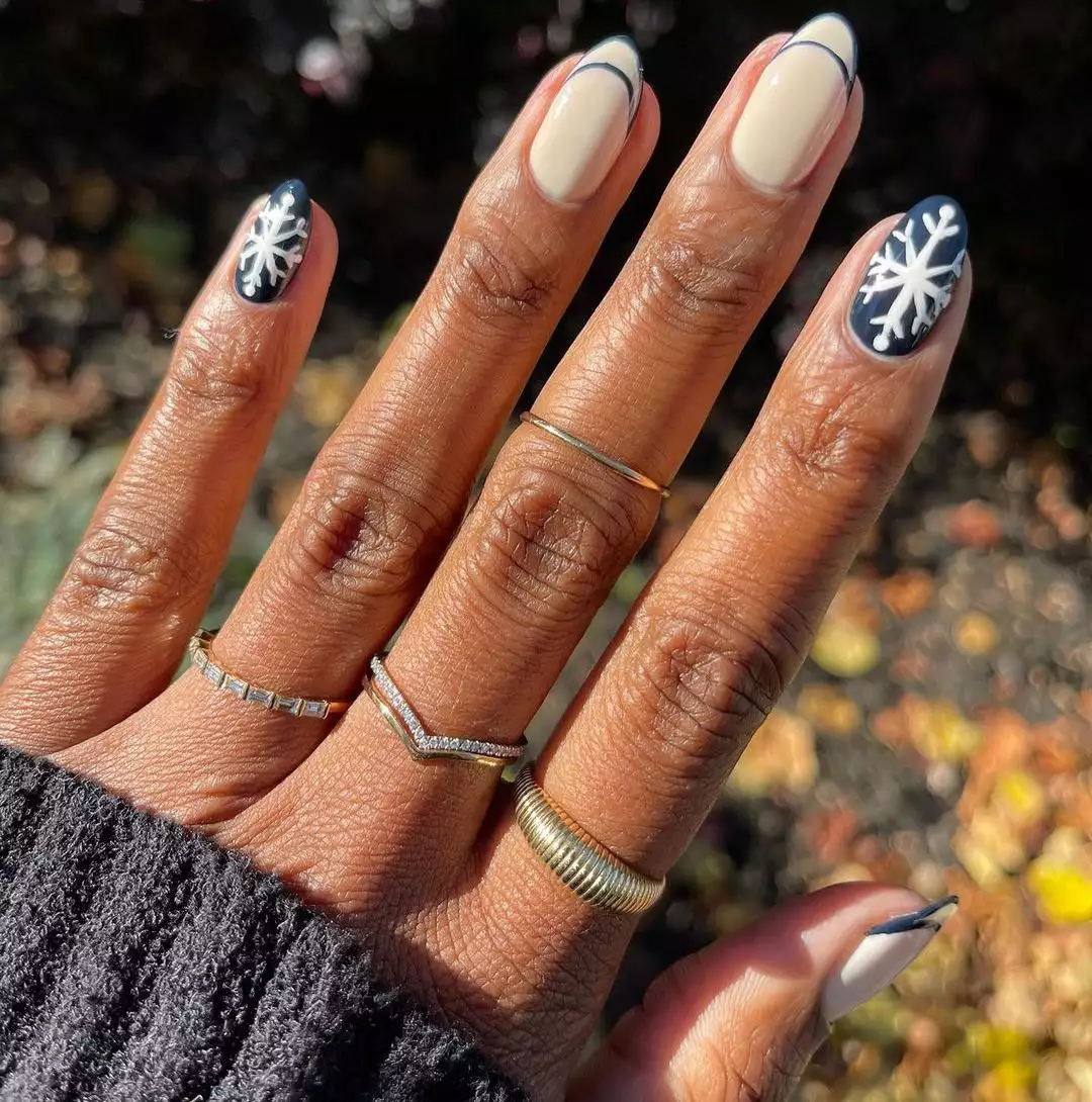 navy and white manicure with snowflake designs