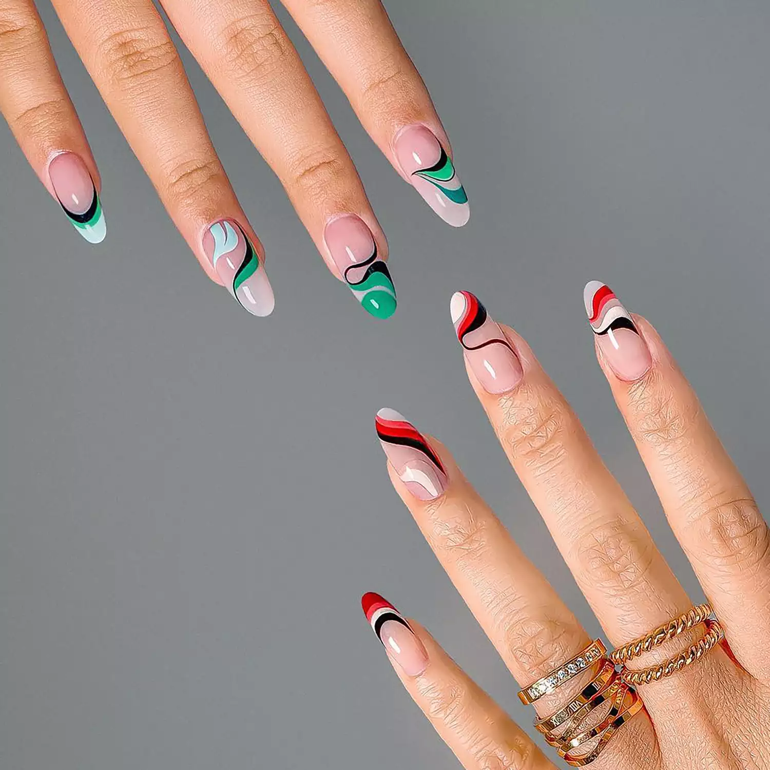 Green (upper left corner) and red (lower right corner) swirl manicures