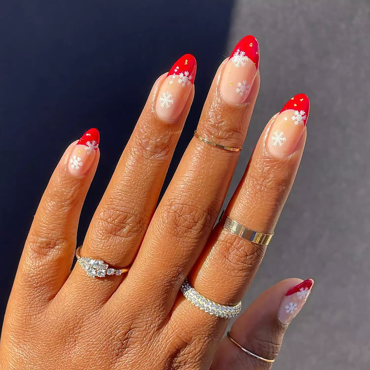 Close up of a red French manicure with white snowflakes