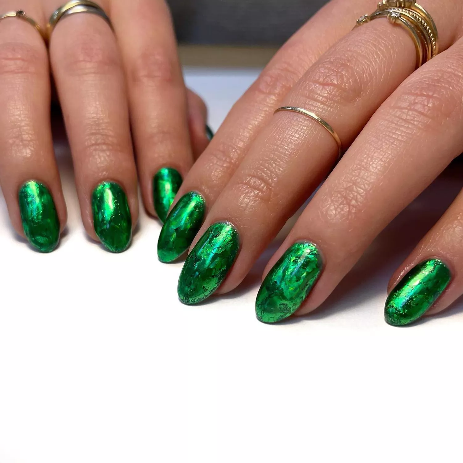 Close up of a bright green, slightly marble mani