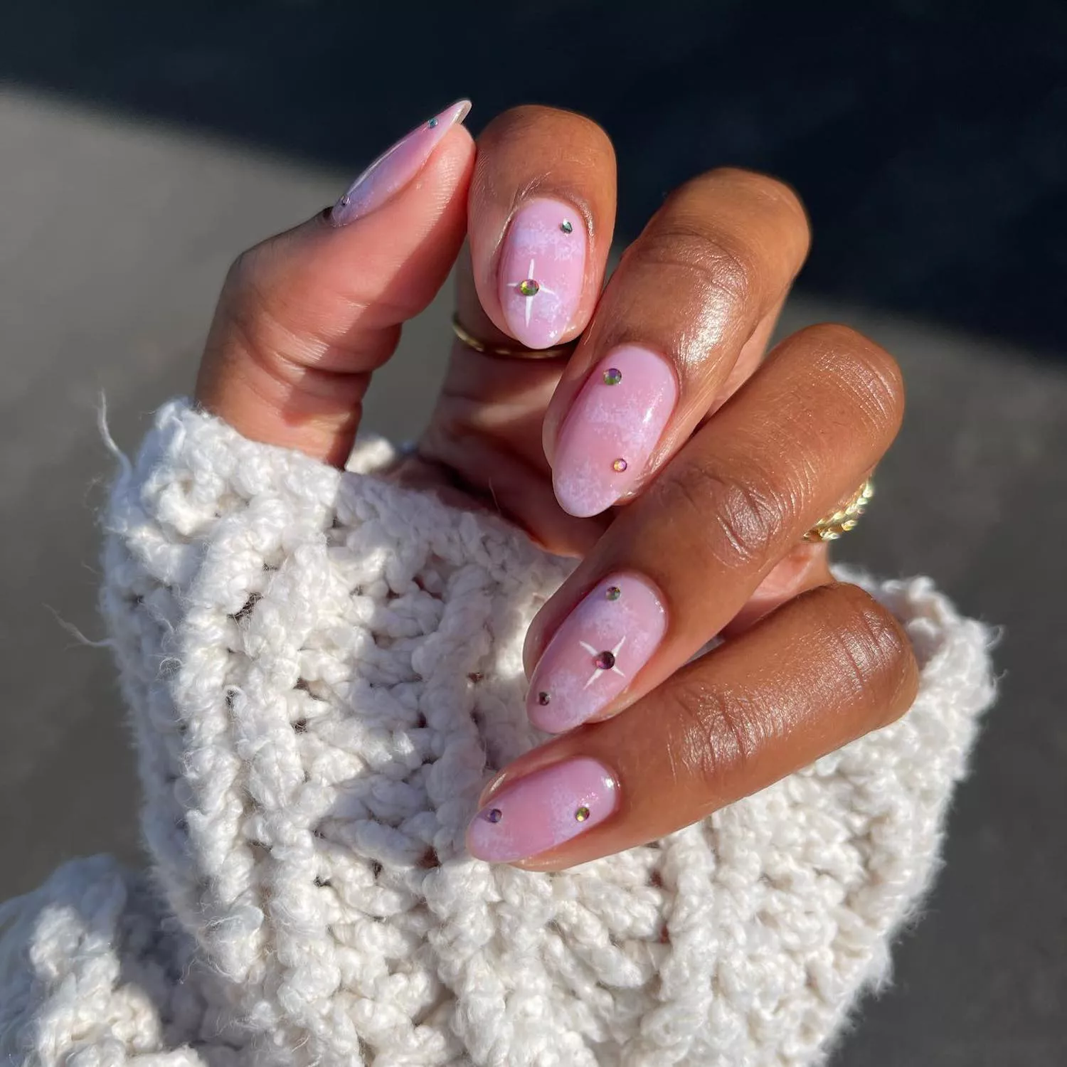 Lavender cloudy manicure with gems and white star ray details