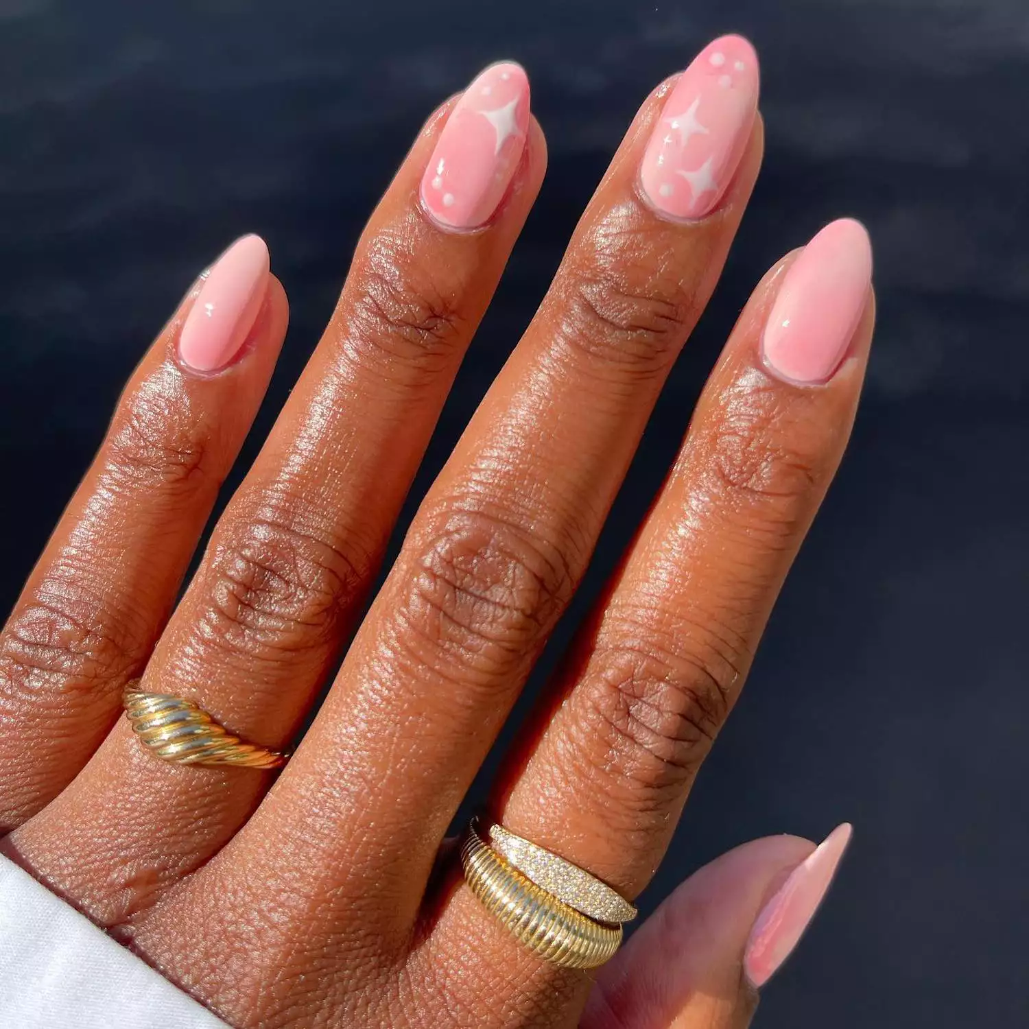 Manicure with cotton candy pink base and pastel sparkle and dot designs