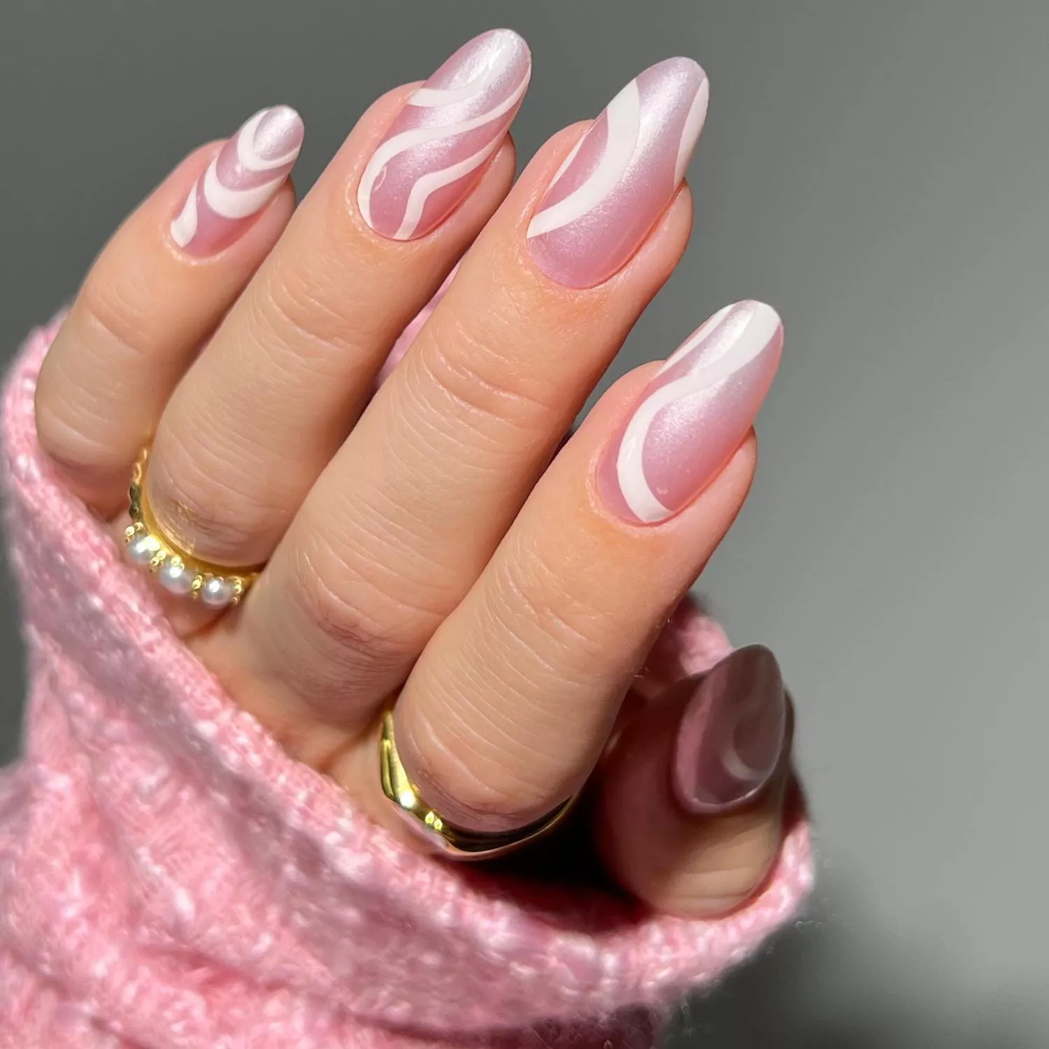 Pearlescent pink chrome nails with white wave designs