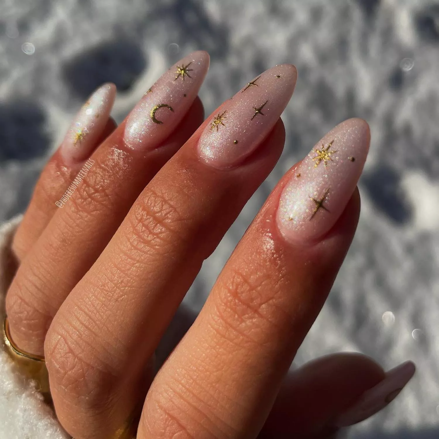 Pink chrome nails with gold star and moon designs