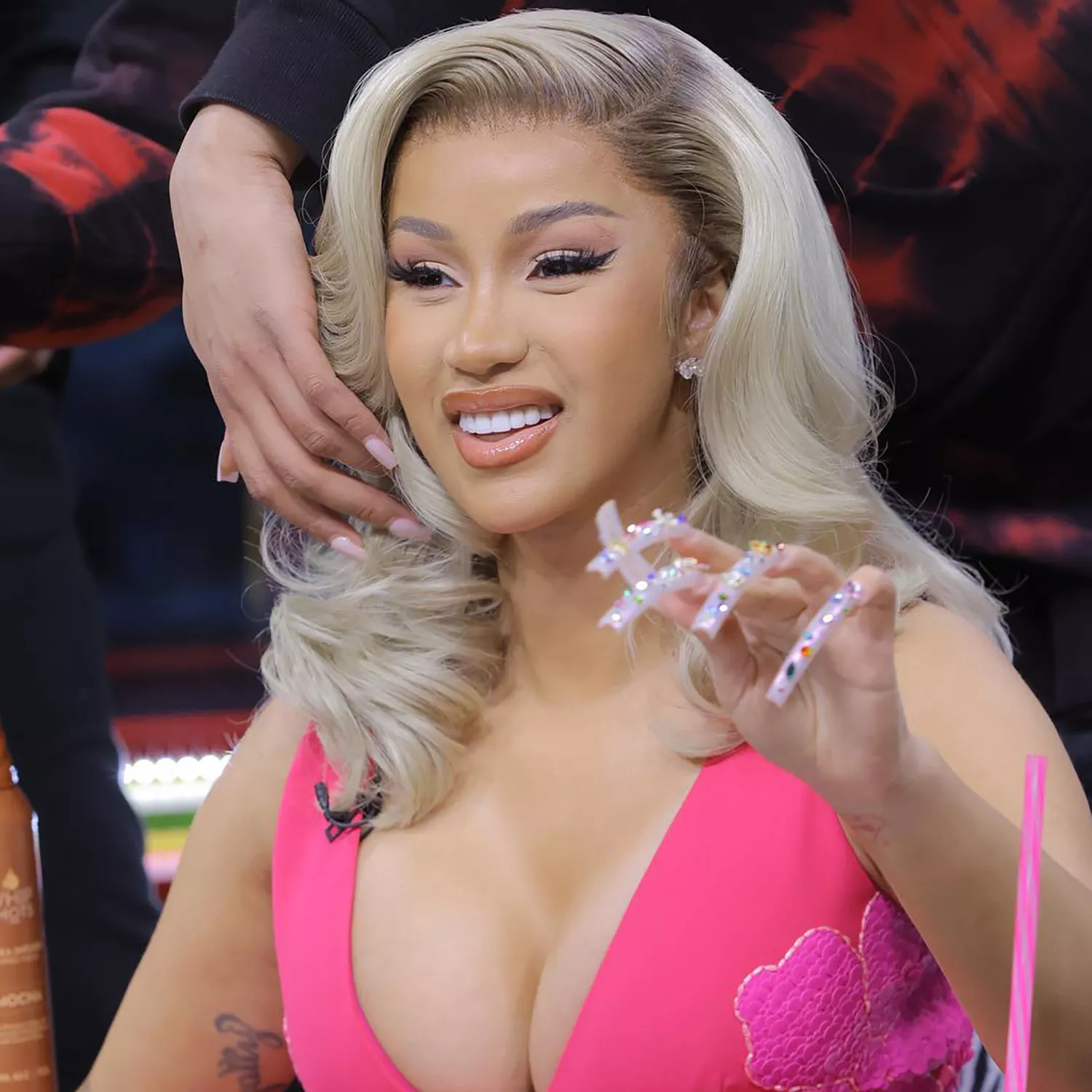 Close up of Cardi B, her hand in front of her face with a dramatic manicure