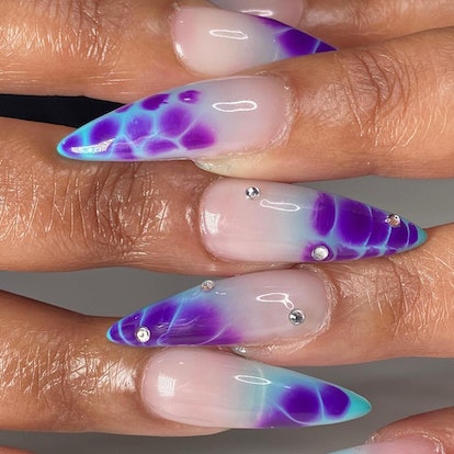 Blue and purple croc print French nails that were created using blooming gel polish.