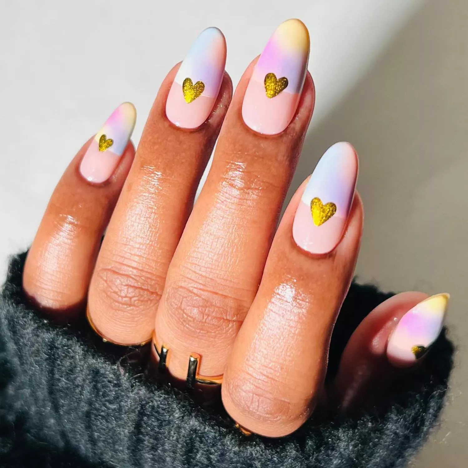 Manicure with pastel aura half-and-half base and gold chrome heart designs