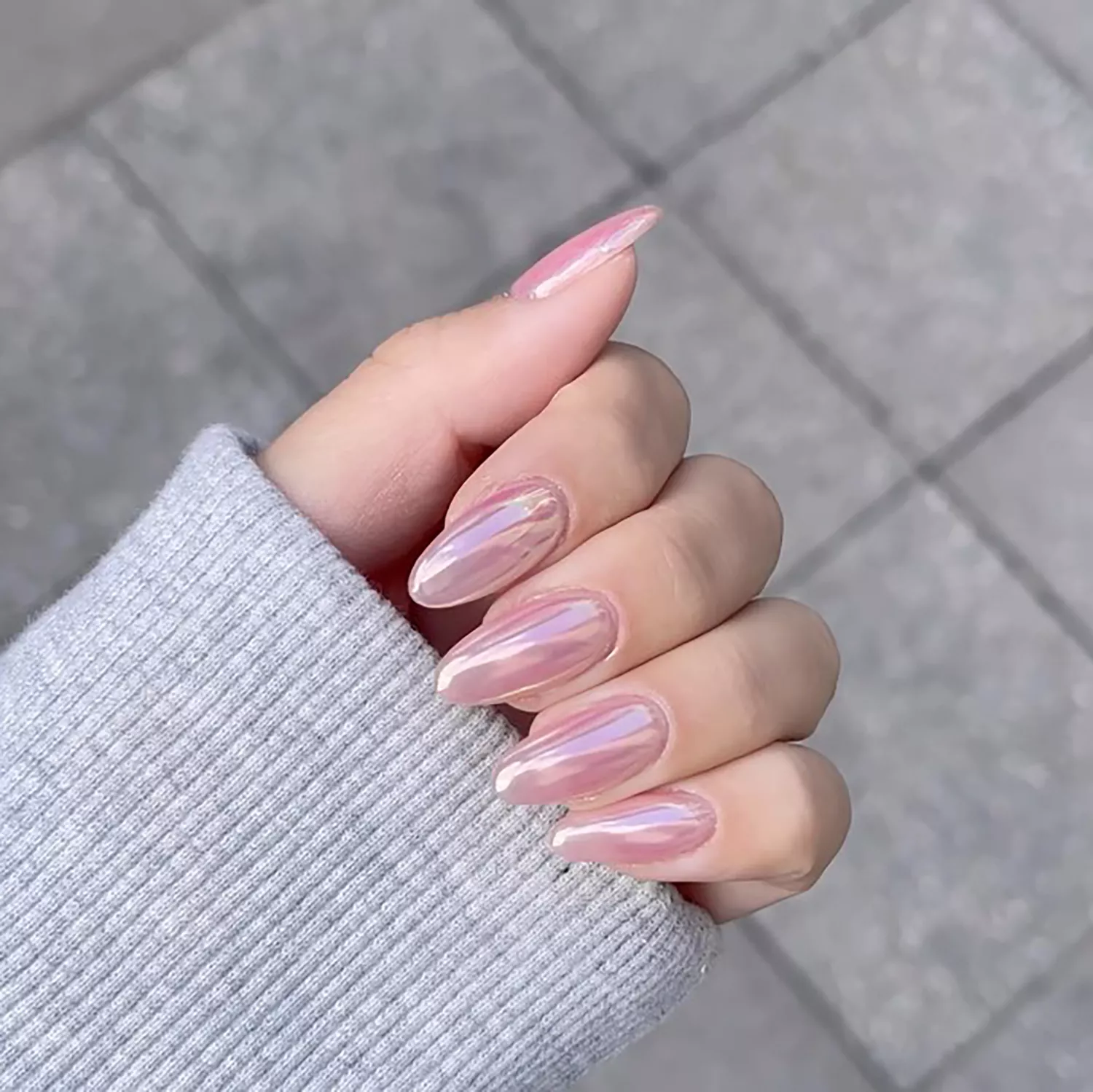 Close up of a pink chrome manicure 