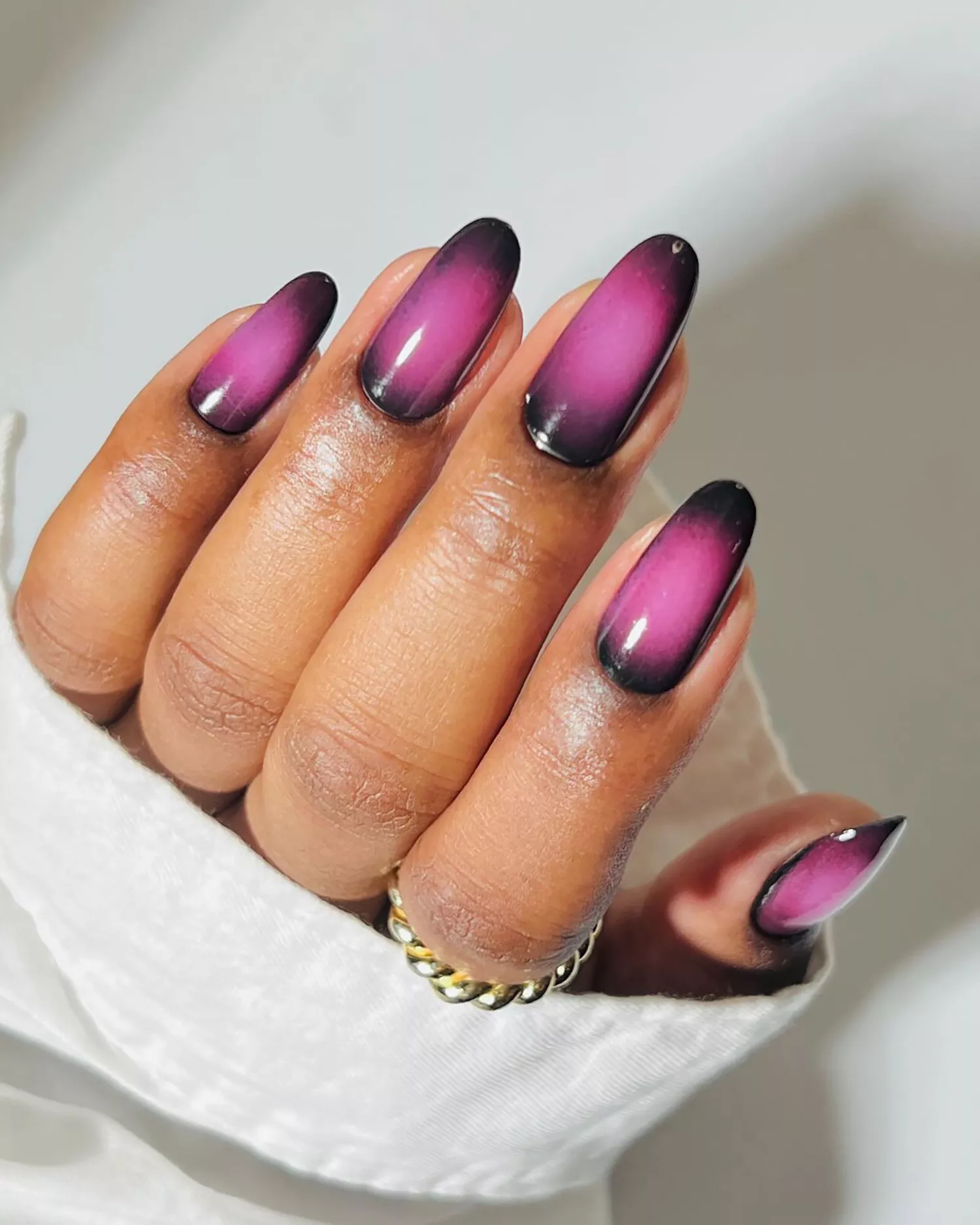 Close up of a dark purple aura manicure