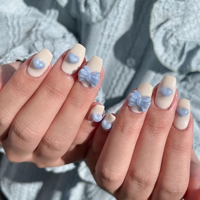 Baby blue ribbon nails.