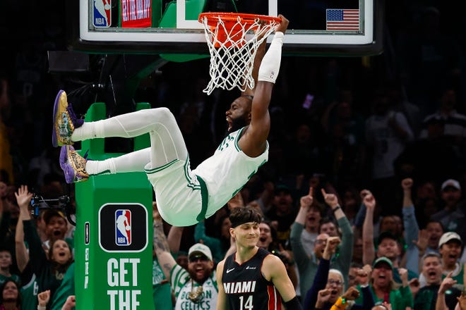 Oct. 27: Boston Celtics guard Jaylen Brown shout after dunking over Miami Heat guard Tyler Herro (14) during the second quarter at TD Garden.