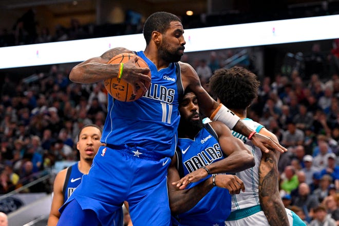 Nov. 5: Dallas Mavericks guard Kyrie Irving (11) grabs a rebound over forward Tim Hardaway Jr. (10) during the second half against the Charlotte Hornets at the American Airlines Center. The Mavericks won 124-118.