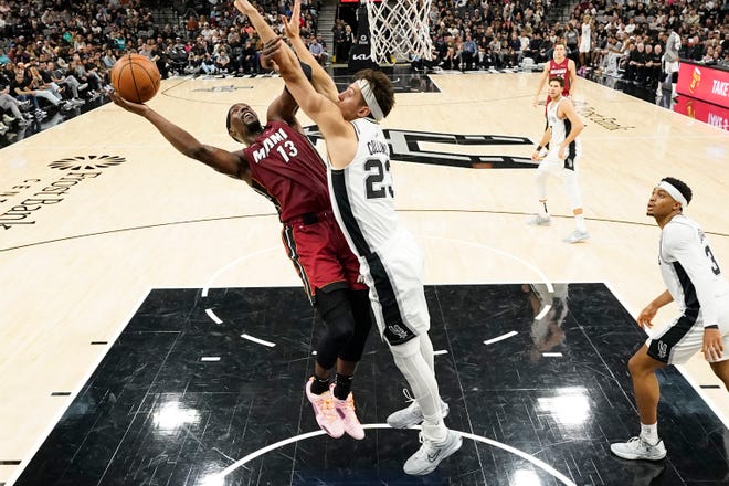 Nov 12: Miami Heat center Bam Adebayo (13) shoots over San Antonio Spurs center Zach Collins (23) during the first half at Frost Bank Center. The Heat won 118-113.