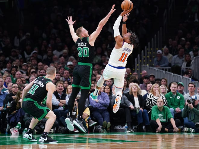 Nov. 13: New York Knicks guard Jalen Brunson (11) jumps to shoot over Boston Celtics forward Sam Hauser (30) at TD Garden. The Celtics won 114-98.