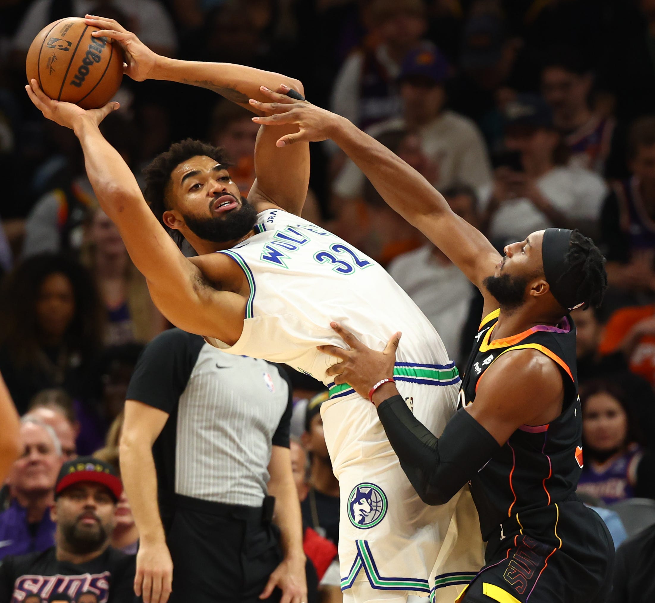 Nov. 15: The Minnesota Timberwolves' Karl-Anthony Towns (32) controls the ball against the Phoenix Suns' Josh Okogie during the first half at Footprint Center.