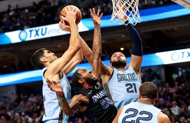 Dec. 1: Memphis Grizzlies forwards Santi Aldama (7) and David Roddy (21) battle for the ball with Dallas Mavericks forward Derrick Jones Jr. (55).