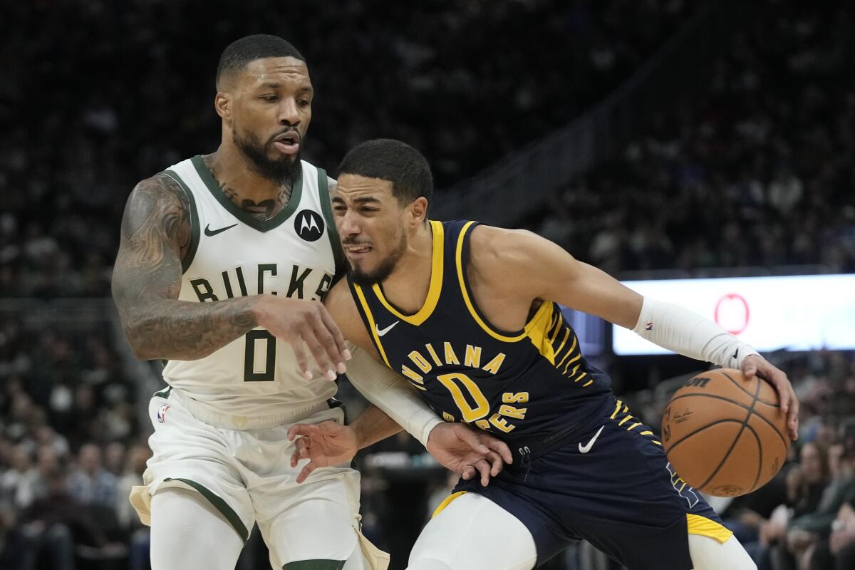 Indiana Pacers' Tyrese Haliburton tries to get past Milwaukee Bucks' Damian Lillard during the second half of an NBA basketball game Wednesday, Dec. 13, 2023, in Milwaukee. (AP Photo/Morry Gash)