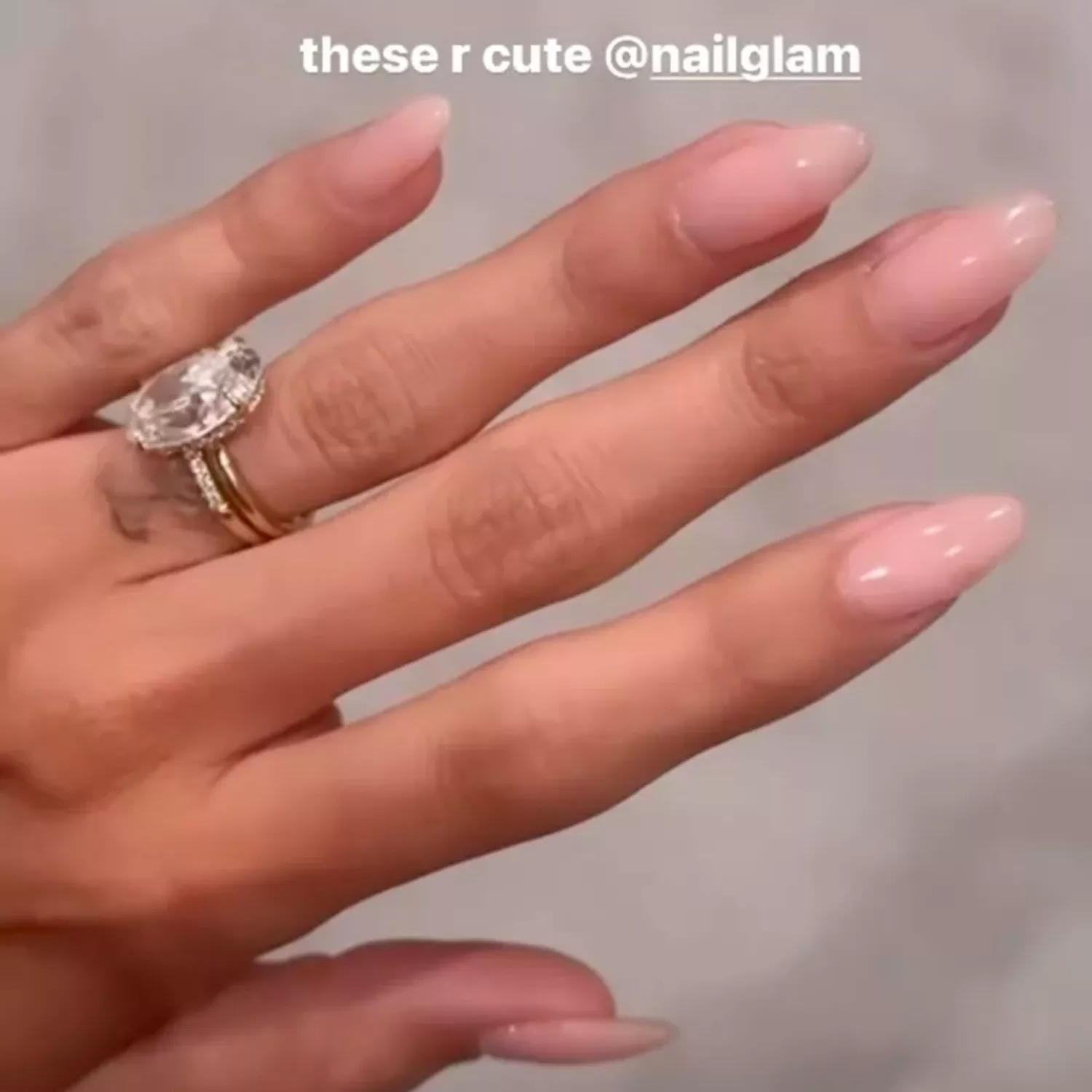 Hailey Bieber posting a story of her strawberry milk nails.