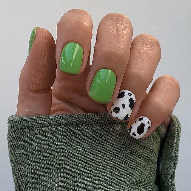 green and cow print short nail design