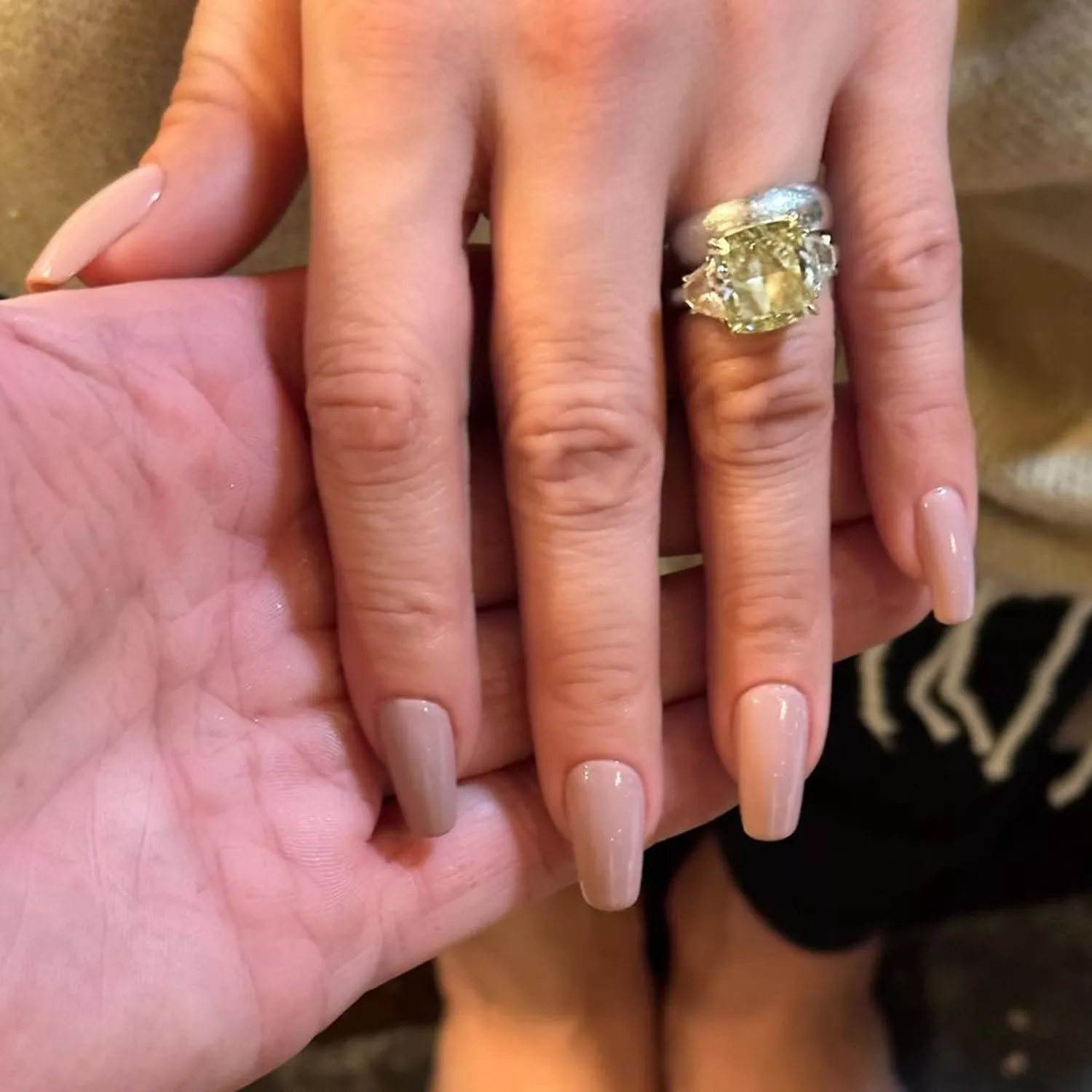 Jennifer Lopez's hand with a nude, glossy manicure