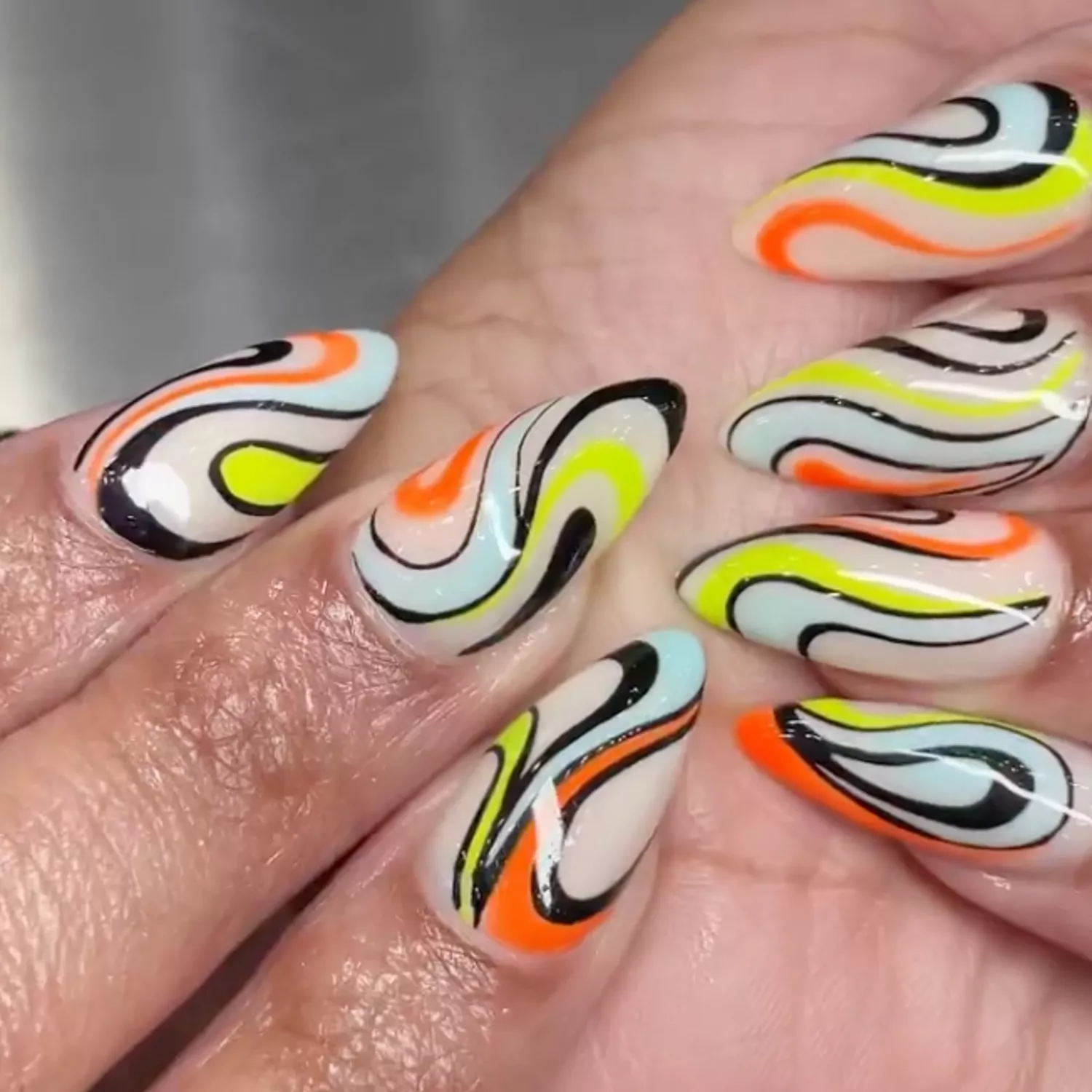 Halloween Swirl Nails in shades of orange, yellow, black