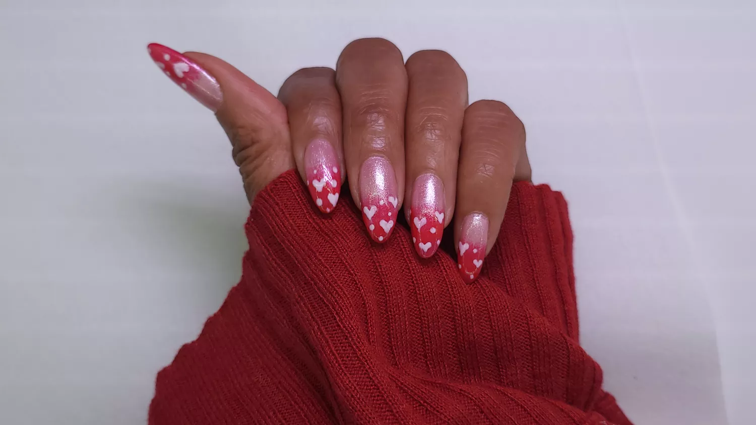 A woman wearing a simple nail design featuring 