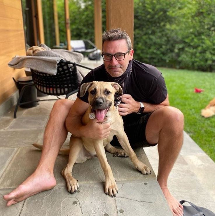 Jon Hamm is a new dog dad! The actor was all smiles hanging out with his new adopted puppy Splash in a photo shared by animal rescue I Stand with My Pack on Sept. 15, 2020.