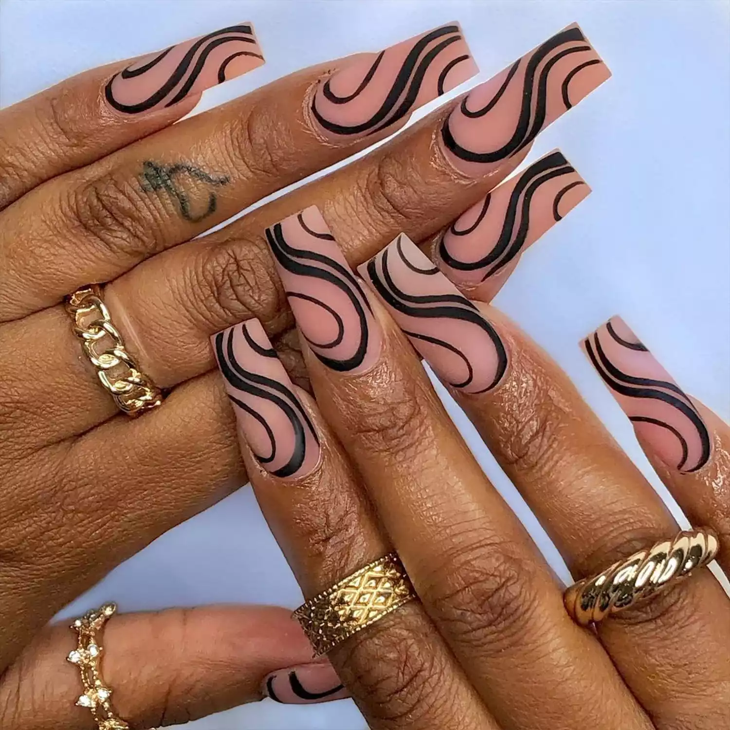 Matte Black Swirl Nails with a neutral-colored base