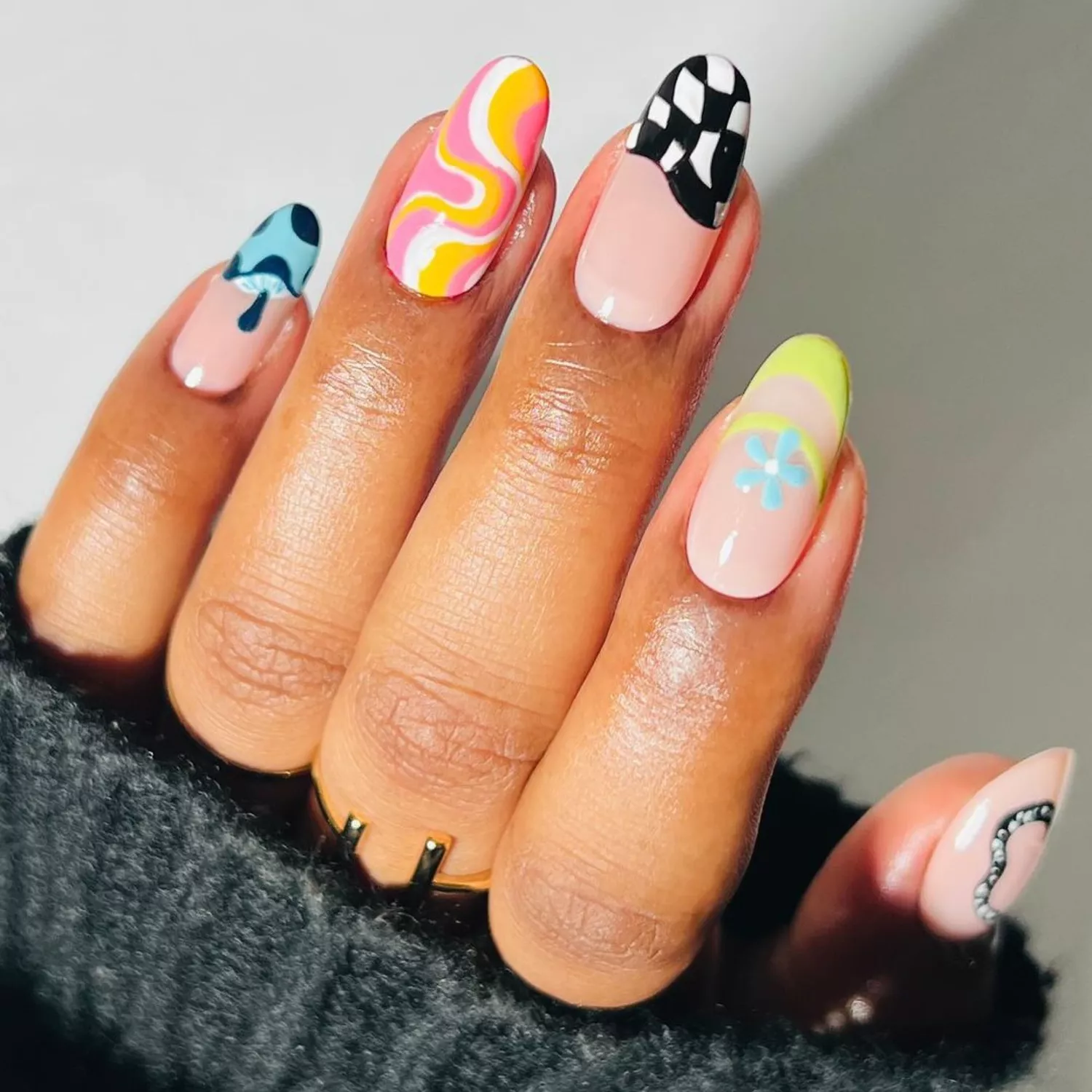 a manicure with multiple designs in many colors