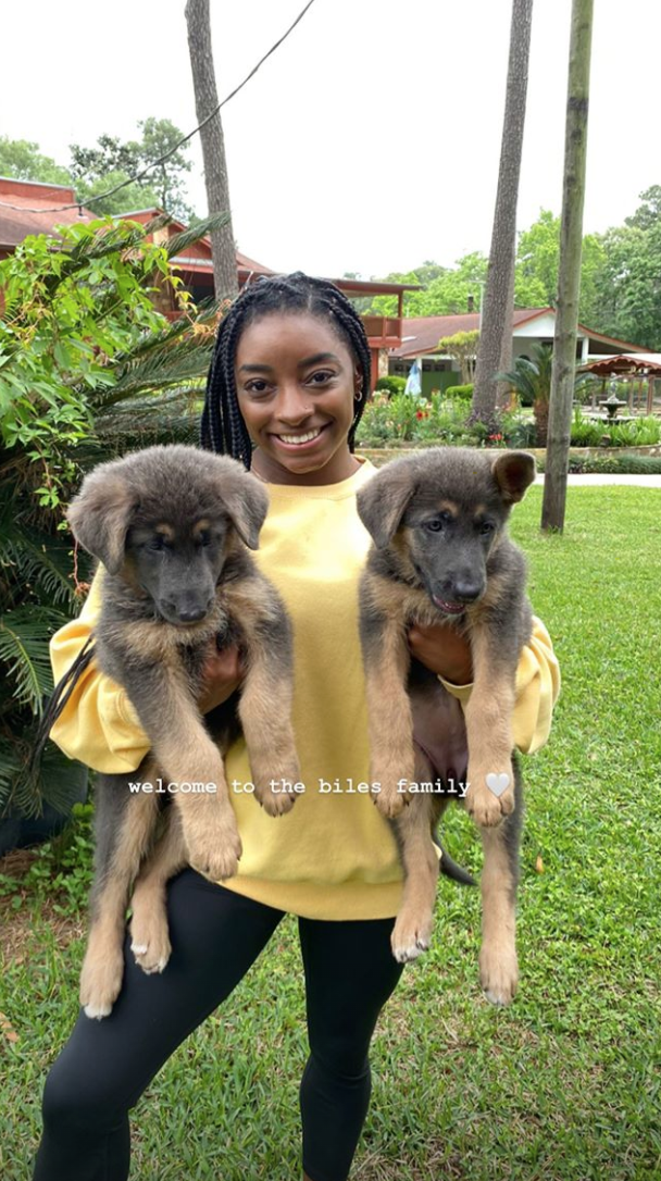 Olympic gymnast Simone Biles debuts her two new puppies on Easter Sunday during coronavirus quarantine.