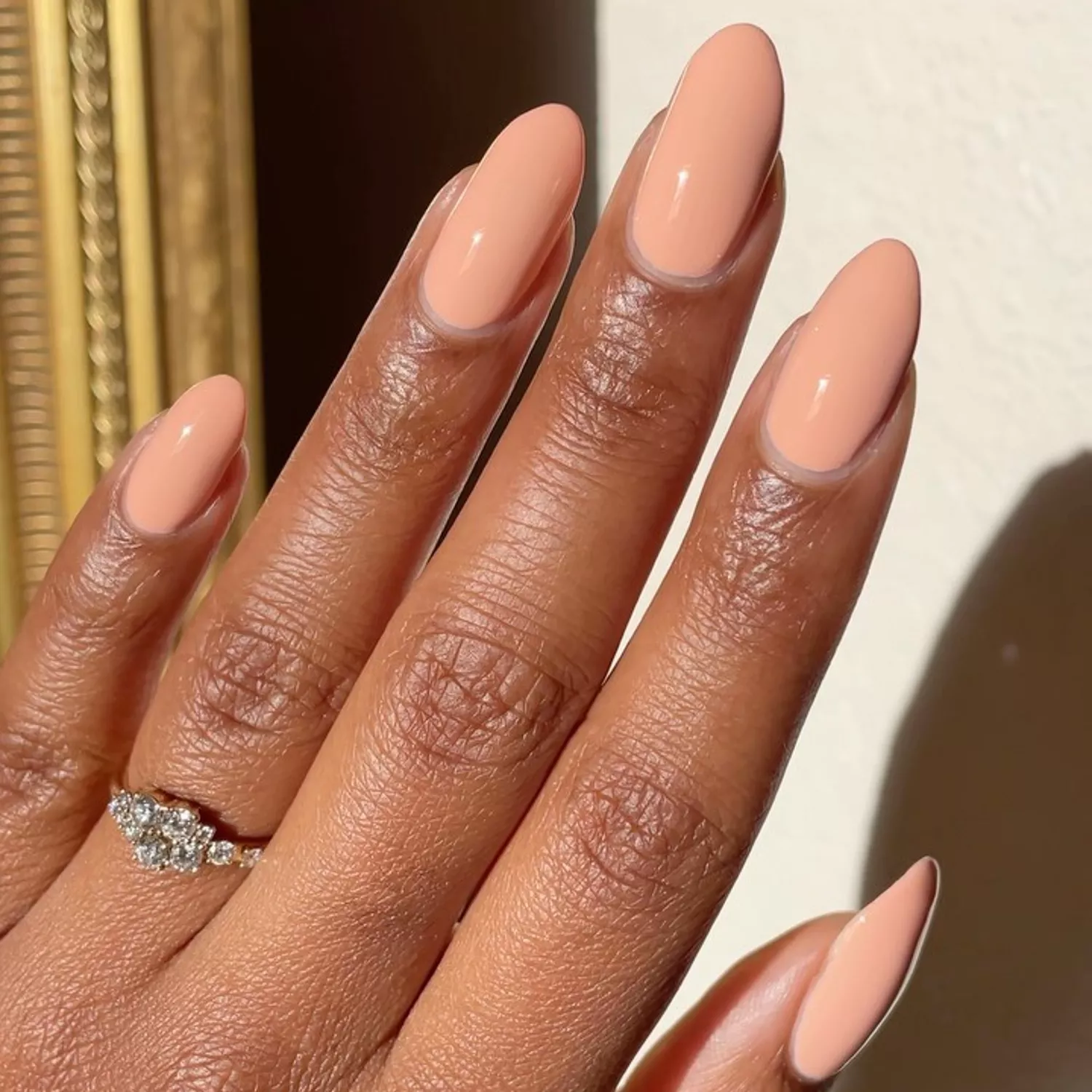 Close up of finger tips with peachy-nude fingernails