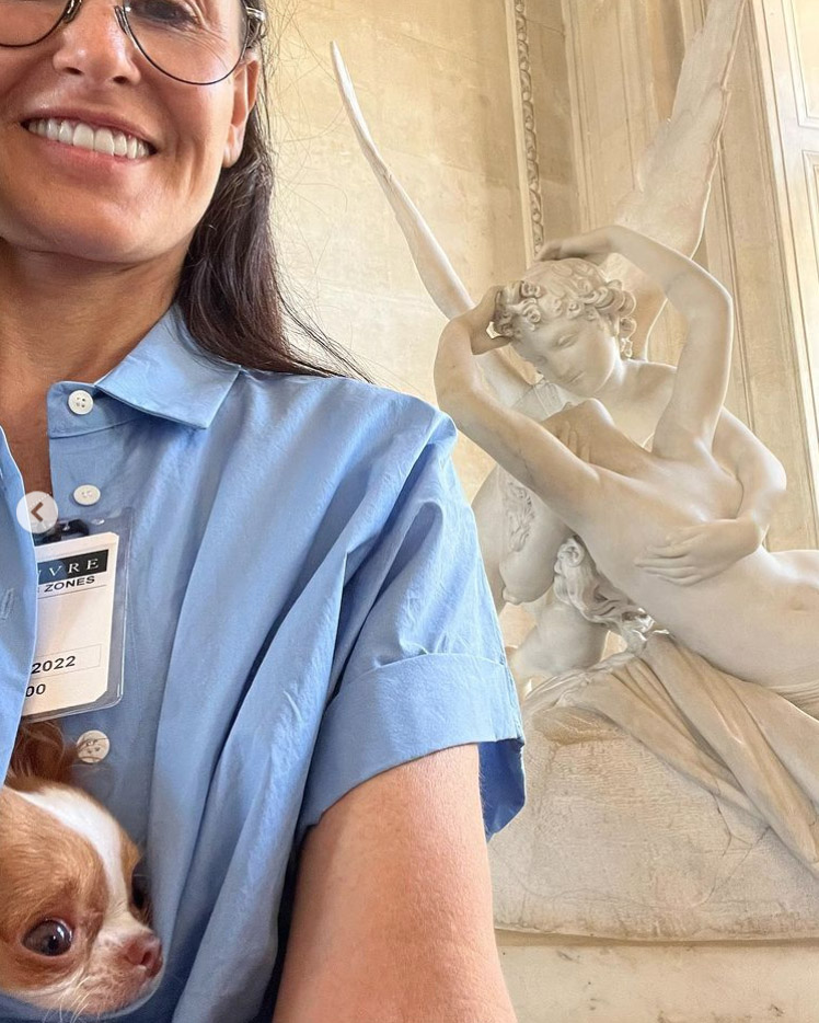 Demi Moore is all smiles while walking through the Louvre Museum with her dog Pilaf hanging out in her shirt on Wednesday, July 13, 2022.