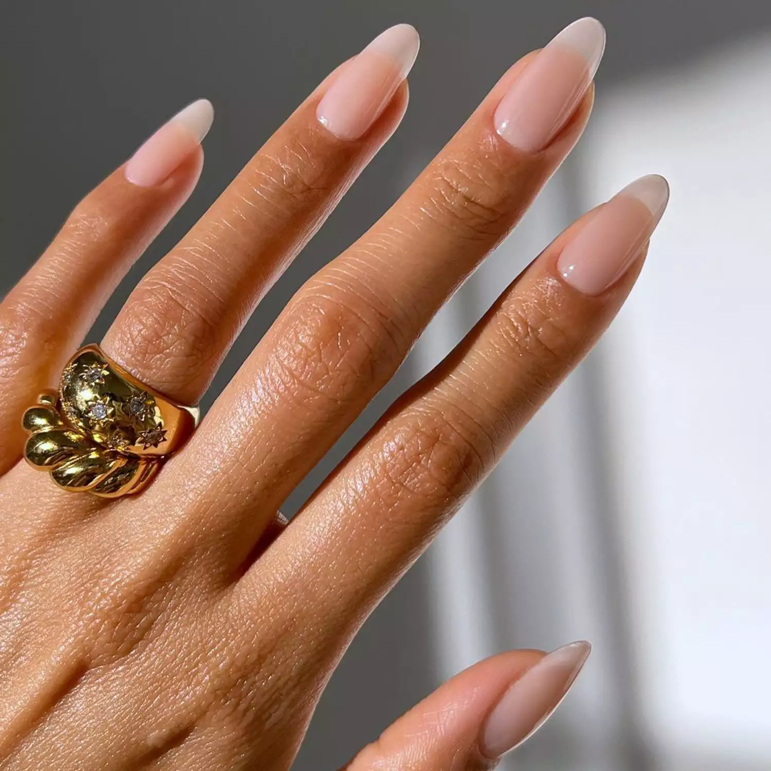 Close up of a sheer, natural pinkish manicure 