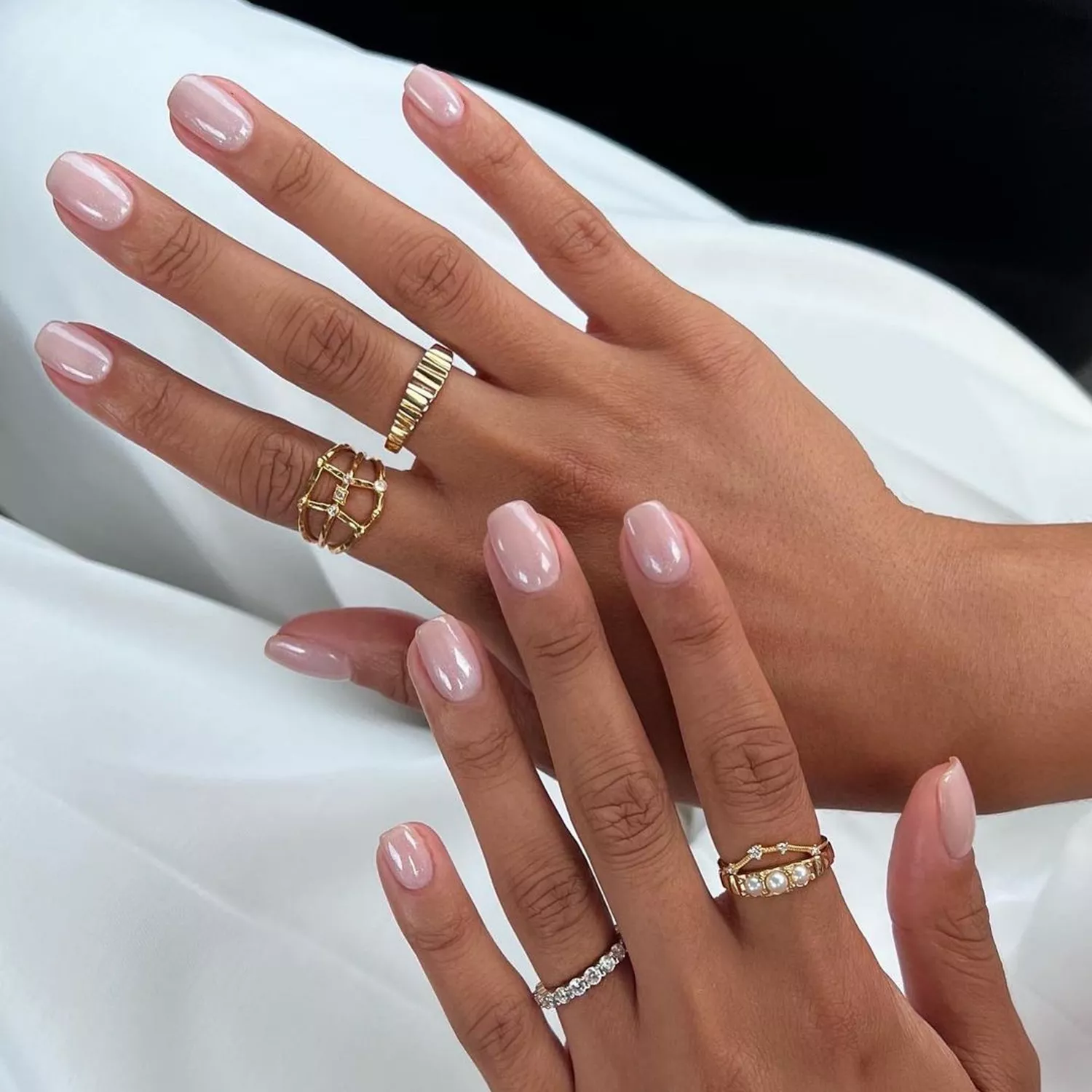 Two hands with glossy, squoval nails