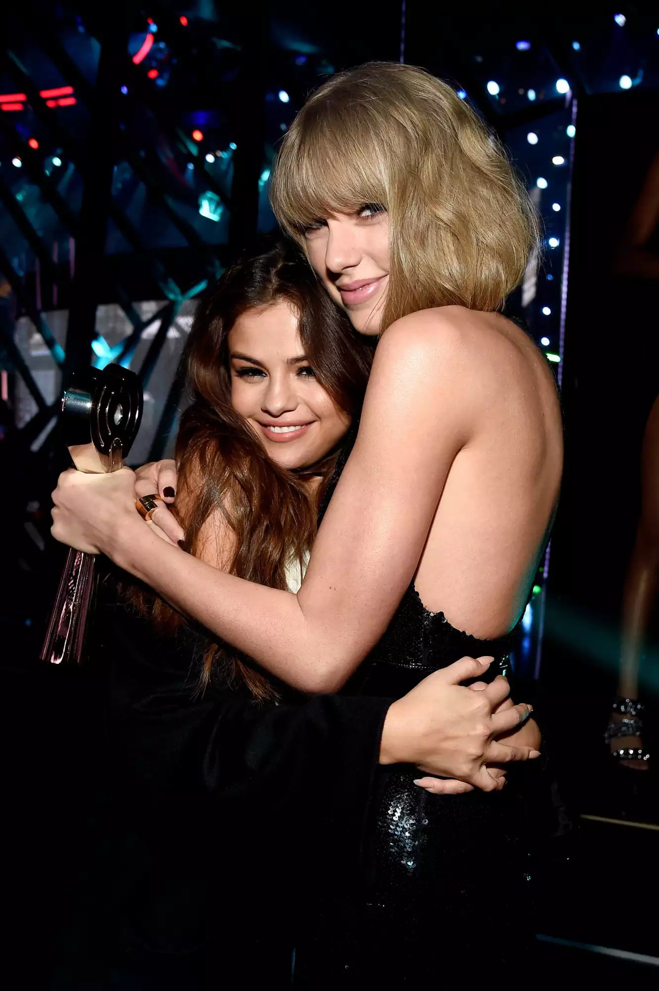 INGLEWOOD, CALIFORNIA - APRIL 03: Singer Taylor Swift (R), winner of the Album of the Year award for '1989,' embraces actress/singer Selena Gomez backstage at the iHeartRadio Music Awards which broadcasted live on TBS, TNT, AND TRUTV from The Forum on April 3, 2016 in Inglewood, California. (Photo by Kevin Mazur/Getty Images for iHeartRadio / Turner)