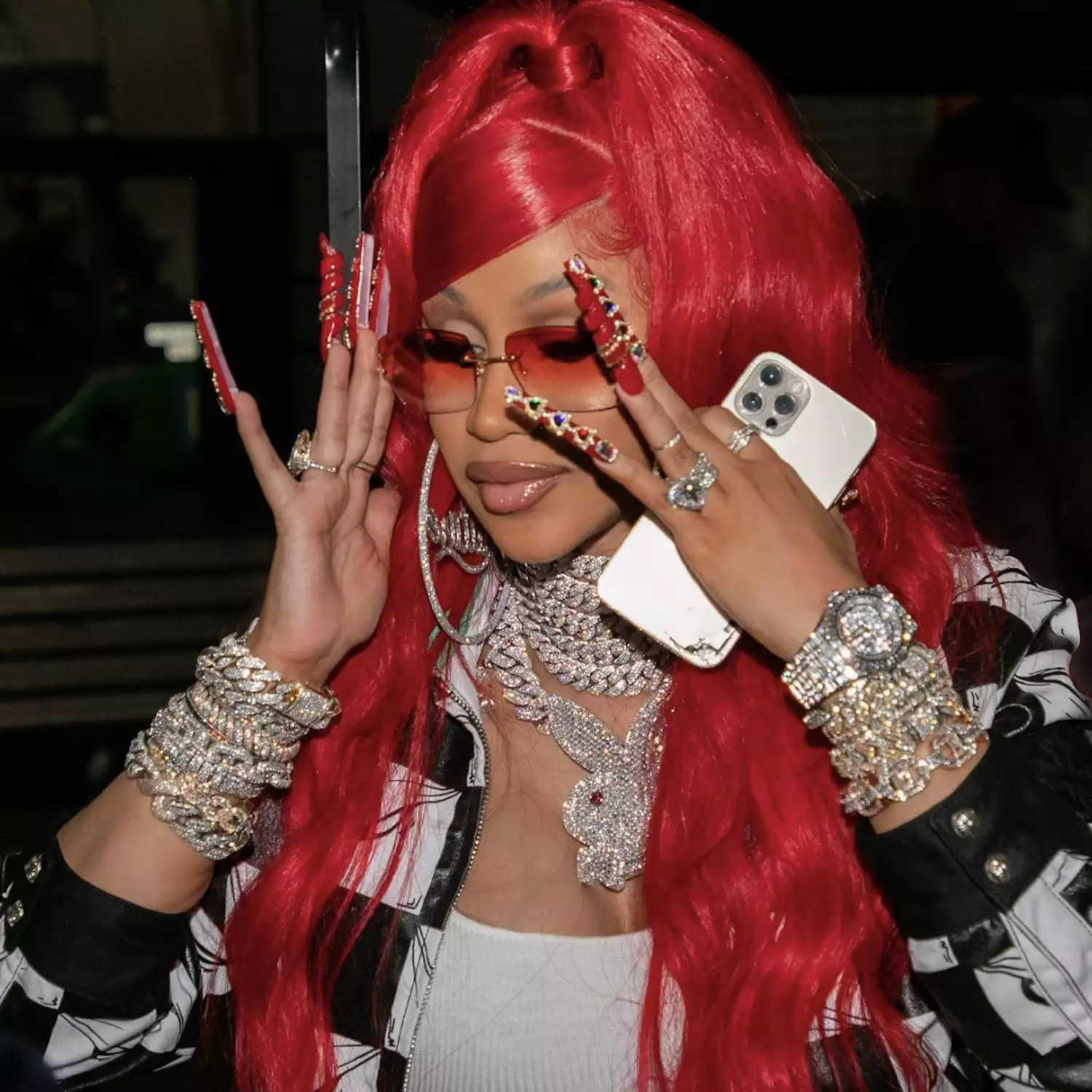 Close up of Cardi B with long red nails and jewel accents