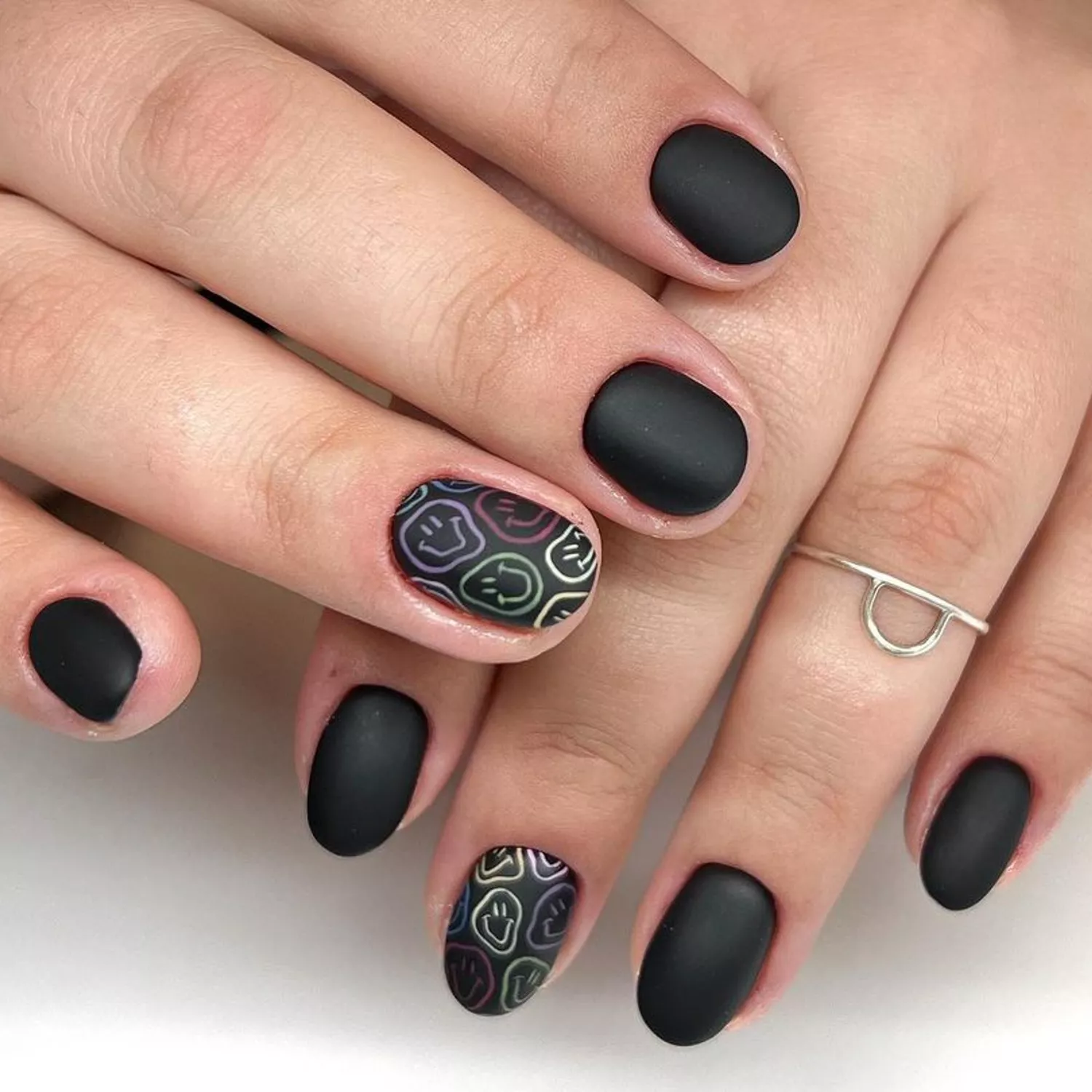 matte black nails with smiley face designs