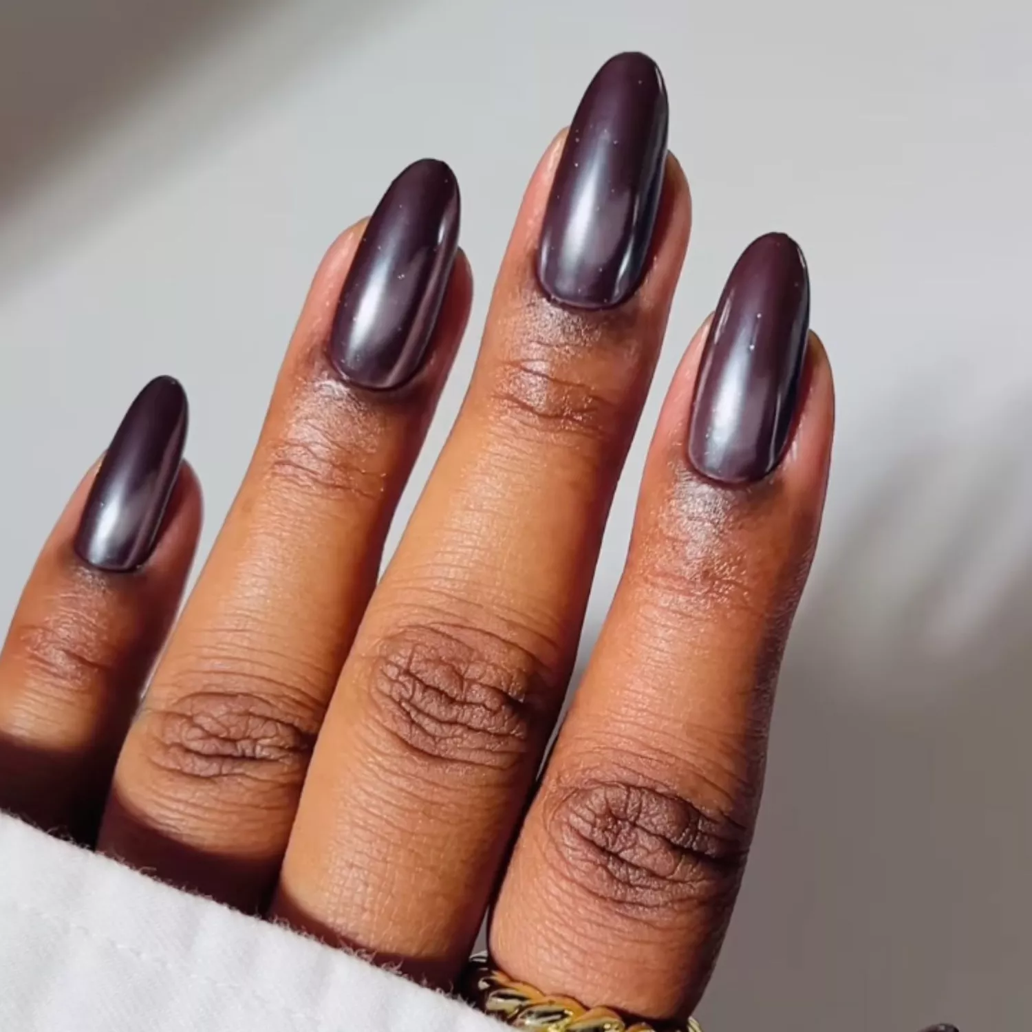 A brown manicure with a chrome finish