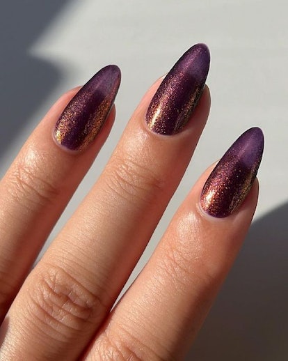 One of the most popular winter nail polish color trends for 2024 is glittering plum.