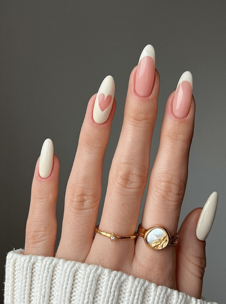 classy almond french tip white wedding nails with a heart bridal design on the ring finger