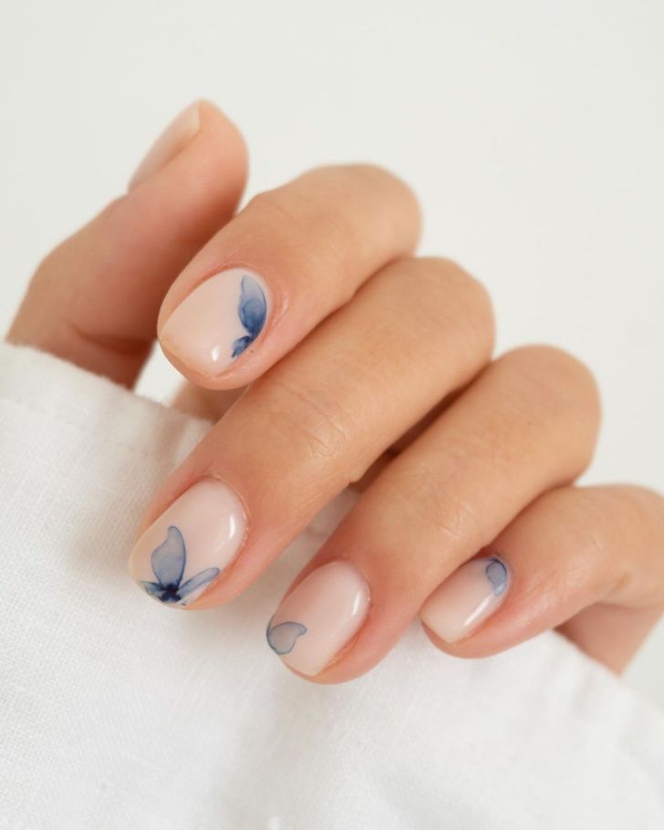 bride wearing classy blue butterfly short wedding nails in a watercolor style painting design