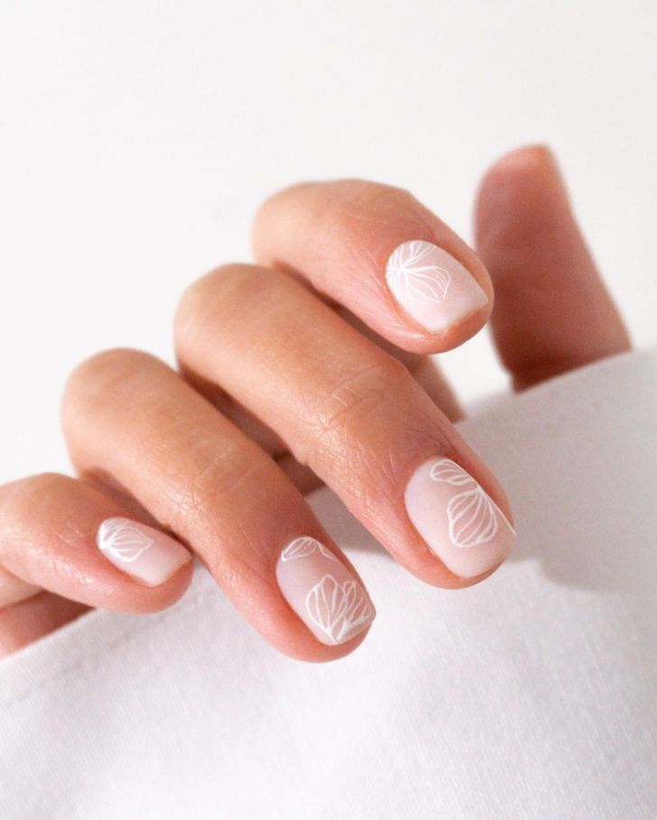 classy short flower petal white wedding nails with a simple light pink base coat