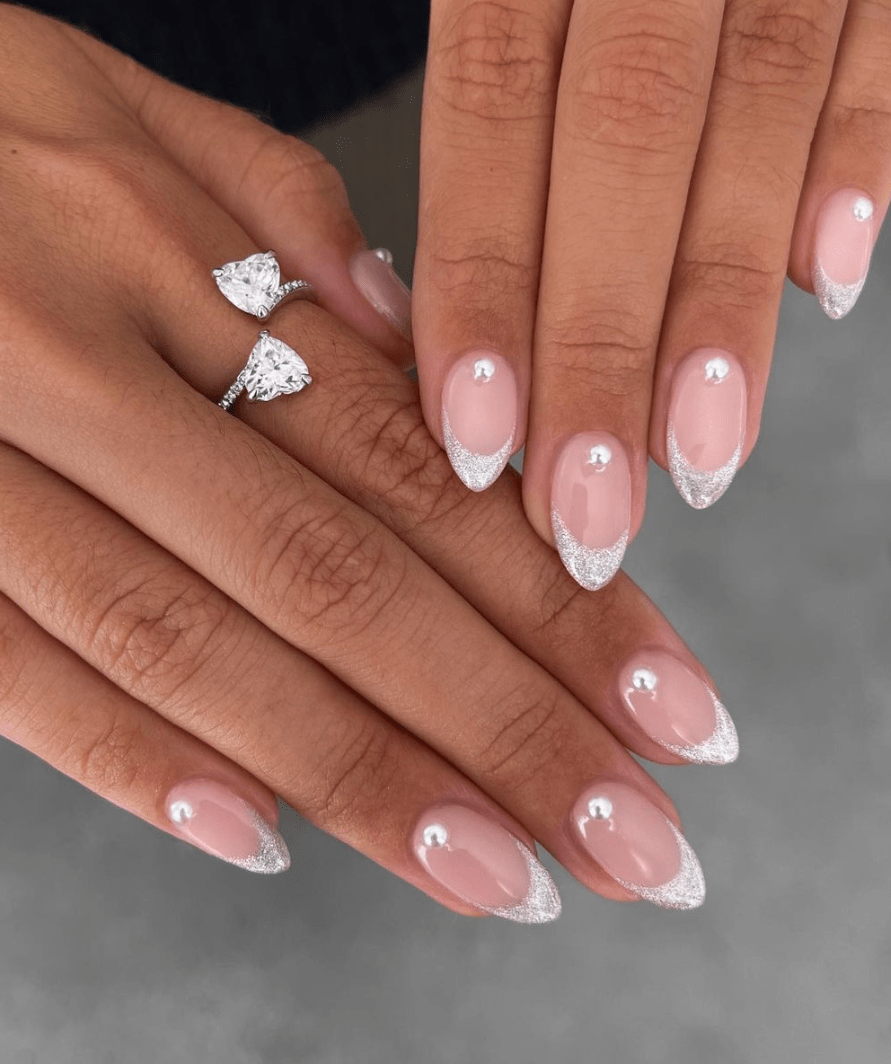 bridal manicure with a classy sparkly silver french tip and pearl detail