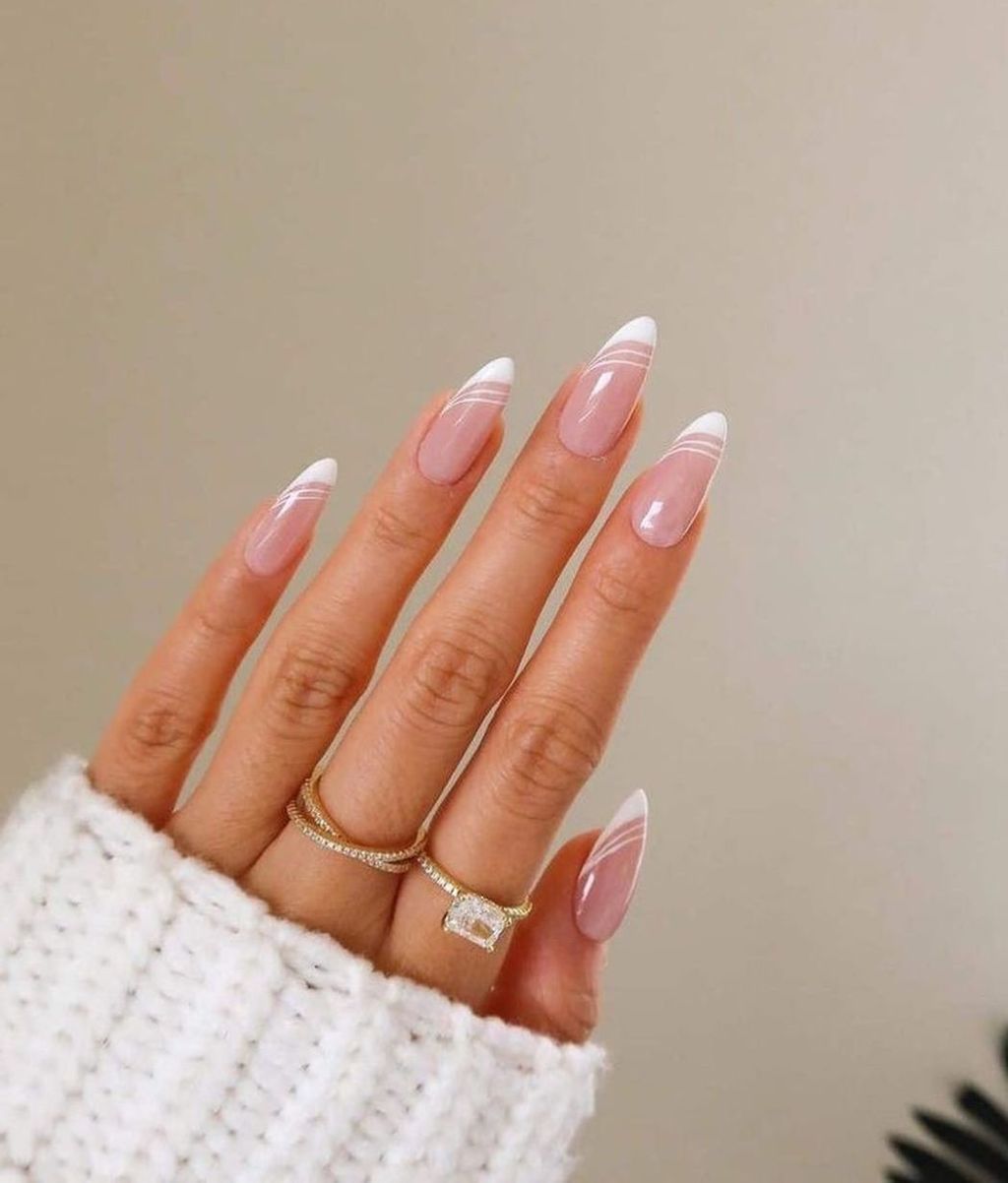 bride showing her classy swirl french tip white wedding nails