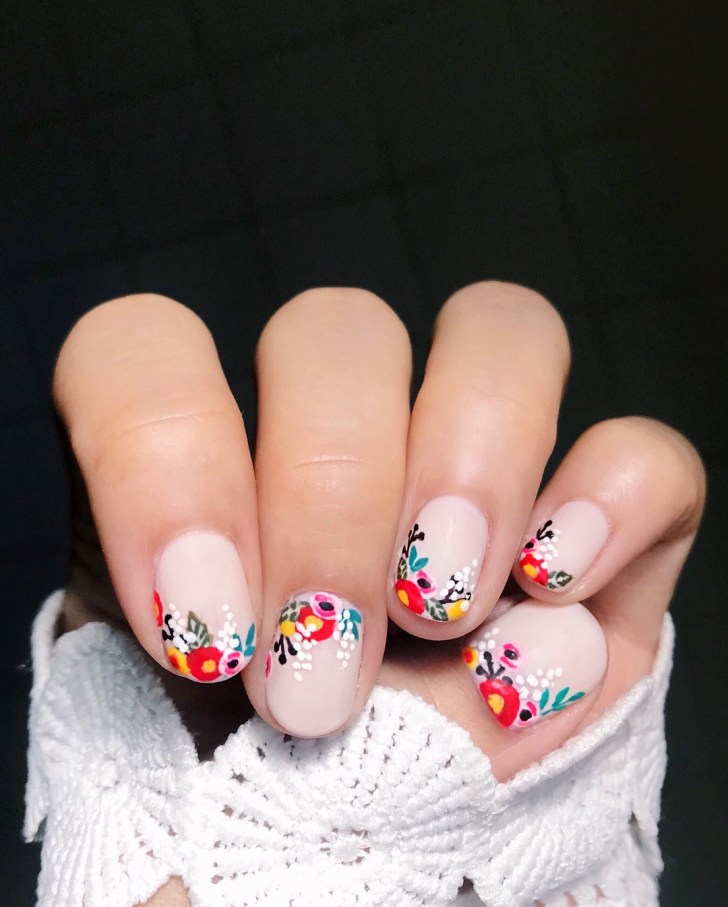 illustrated colorful flower nail designs for weddings with a light pink polish base