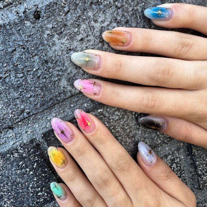 colorful mismatched Taylor Swift nails with celestial ombre aura designs with gold stars inspired by each album on the Eras Tour